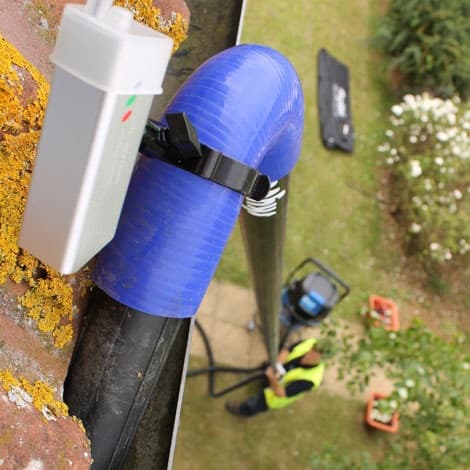 A gutter being cleaned from the ground with the SkyVac across the Waikato